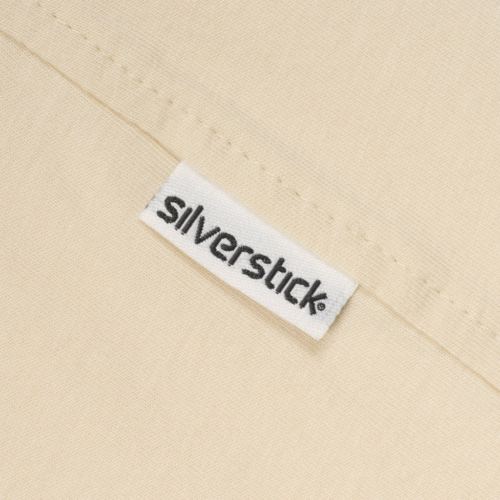 Close-up of a 'Silverstick' label on beige fabric.